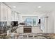 Modern kitchen featuring granite countertops, stainless steel appliances, and an ocean view at 19450 Gulf Blvd # 401, Indian Shores, FL 33785