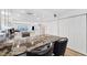 This bright kitchen has granite countertops, white cabinets, and opens to the living area with ocean views at 19450 Gulf Blvd # 401, Indian Shores, FL 33785