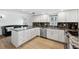 Updated kitchen with stainless appliances, dark marble counters, white cabinets and island seating at 19450 Gulf Blvd # 401, Indian Shores, FL 33785