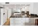 Bright kitchen featuring granite countertops, white cabinets, and stainless steel appliances at 19450 Gulf Blvd # 401, Indian Shores, FL 33785