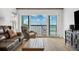 Cozy living room with ocean view, slider doors, and comfortable seating at 19450 Gulf Blvd # 401, Indian Shores, FL 33785