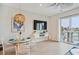 Bright dining area with stylish lighting, a glass table, and a sliding glass door to the balcony at 145 Brightwater Dr # 2, Clearwater, FL 33767