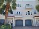 Charming three-story townhome with a private garage, balconies, and tropical landscaping at 145 Brightwater Dr # 2, Clearwater, FL 33767