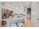 Modern kitchen features an island, granite counters, stainless appliances, and ample cabinet space at 145 Brightwater Dr # 2, Clearwater, FL 33767