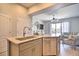 Modern kitchen with granite countertops, a stainless steel dishwasher, and views of the living area at 145 Brightwater Dr # 2, Clearwater, FL 33767