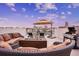 Relaxing rooftop deck with comfortable seating, a fire pit, grill, and stunning city views at 145 Brightwater Dr # 2, Clearwater, FL 33767