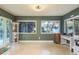 Bright and airy living room with large windows, sliding glass doors, and tiled floor at 1611 San Charles Dr, Dunedin, FL 34698