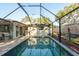 Screened-in pool area with brick trim offers a private outdoor space at 1611 San Charles Dr, Dunedin, FL 34698