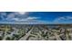 Expansive aerial view of the community highlighting its proximity to a lake and showcasing the neighborhood layout at 2258 World Parkway W Blvd # 8, Clearwater, FL 33763