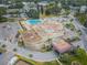 An overhead shot of a building with ample parking and a refreshing swimming pool, surrounded by lush greenery at 2258 World Parkway W Blvd # 8, Clearwater, FL 33763