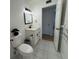 Modern bathroom features a white vanity with black fixtures, tiled floors, and a clean aesthetic at 2258 World Parkway W Blvd # 8, Clearwater, FL 33763