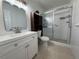 Modern bathroom features a white vanity, tiled floors, and a glass-enclosed shower at 2258 World Parkway W Blvd # 8, Clearwater, FL 33763