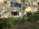 Exterior view of condo with garden and lush landscaping at 2258 World Parkway W Blvd # 8, Clearwater, FL 33763