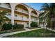 Beautiful multi-story condominium building with lush landscaping and architectural archways at 2258 World Parkway W Blvd # 8, Clearwater, FL 33763
