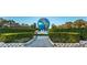Monumental globe with garden landscaping and surrounding trees at 2258 World Parkway W Blvd # 8, Clearwater, FL 33763