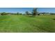 View of the lush green golf course featuring mature trees on a clear day at 2258 World Parkway W Blvd # 8, Clearwater, FL 33763