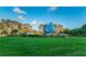 Lush green lawn with mature trees and manicured shrubs surrounding a large decorative globe at 2258 World Parkway W Blvd # 8, Clearwater, FL 33763