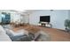 Bright and open living room with wood floors features modern furniture and a dining area at 2258 World Parkway W Blvd # 8, Clearwater, FL 33763