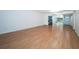 Bright living room featuring hardwood floors and a spacious layout with a view to the kitchen at 2258 World Parkway W Blvd # 8, Clearwater, FL 33763