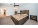 Spacious main bedroom featuring a custom bed frame with storage, carpet, and a ceiling fan at 2258 World Parkway W Blvd # 8, Clearwater, FL 33763