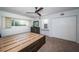Spacious main bedroom featuring a custom bed frame with storage, carpet, and a ceiling fan at 2258 World Parkway W Blvd # 8, Clearwater, FL 33763