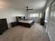 Spacious main bedroom featuring a custom bed frame with storage, carpet, and a ceiling fan at 2258 World Parkway W Blvd # 8, Clearwater, FL 33763