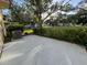 Private concrete condo patio with lawn view, featuring a modern A/C unit at 2258 World Parkway W Blvd # 8, Clearwater, FL 33763