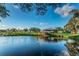 Picturesque pond with wooden dock and clear reflection, surrounded by lush landscaping at 2258 World Parkway W Blvd # 8, Clearwater, FL 33763