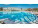 A sparkling blue pool surrounded by lounge chairs and colorful umbrellas, ideal for relaxation and recreation at 2258 World Parkway W Blvd # 8, Clearwater, FL 33763