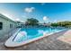 A refreshing blue swimming pool with brick surround, perfect for relaxation on a sunny day at 2258 World Parkway W Blvd # 8, Clearwater, FL 33763