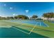 Exterior view of outdoor tennis courts on a sunny day. Blue and green courts at 2258 World Parkway W Blvd # 8, Clearwater, FL 33763