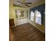 Dining room features wood floor, built in white storage cabinets, and bright yellow walls at 35042 Colony Hills Dr, Zephyrhills, FL 33541