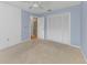 Cozy bedroom featuring a ceiling fan, neutral carpet, and an abundance of closet space at 435 Meadowlark Ln, Palm Harbor, FL 34683