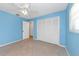 Bedroom with tile flooring, a ceiling fan, and closet space at 435 Meadowlark Ln, Palm Harbor, FL 34683