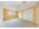 Spacious bedroom with carpet flooring, a ceiling fan, and closet space at 435 Meadowlark Ln, Palm Harbor, FL 34683