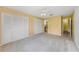 Bedroom with carpet flooring, a ceiling fan, and closet space at 435 Meadowlark Ln, Palm Harbor, FL 34683