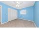 Bedroom with tile flooring, a ceiling fan, and closet space at 435 Meadowlark Ln, Palm Harbor, FL 34683
