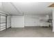 Spacious garage featuring built-in cabinets, work area, and roll-up door at 435 Meadowlark Ln, Palm Harbor, FL 34683