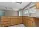 Sunny kitchen featuring wood cabinets, and ample counter space at 435 Meadowlark Ln, Palm Harbor, FL 34683