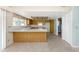 Open kitchen featuring wood cabinets, a breakfast bar, and tile flooring at 435 Meadowlark Ln, Palm Harbor, FL 34683