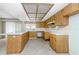 Bright kitchen with wood cabinets, a breakfast bar, and tile flooring at 435 Meadowlark Ln, Palm Harbor, FL 34683