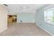 Bright living room with tile floors and an open layout connecting to the kitchen, ideal for entertaining at 435 Meadowlark Ln, Palm Harbor, FL 34683