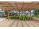 Under pergola, view of the concrete patio showcasing an outdoor space perfect for relaxation and entertaining at 435 Meadowlark Ln, Palm Harbor, FL 34683