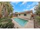 Backyard pool with patio and lush landscaping, creating a serene and private oasis for relaxation at 435 Meadowlark Ln, Palm Harbor, FL 34683