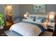 Comfortable bedroom with serene colors, soft lighting, and beach-themed art at 5426 Rushmere Ct, Palmetto, FL 34221