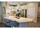 Bright kitchen featuring a stainless steel fridge, gas range and modern white cabinets and island at 5426 Rushmere Ct, Palmetto, FL 34221