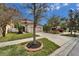 Two-story home with a long driveway, landscaped lawn with mature trees and shrubbery at 12610 Geneva Glade Dr, Riverview, FL 33578