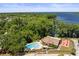 Stunning aerial view of a community pool and adjacent lake surrounded by lush greenery at 2700 Nebraska Ave # 3-201, Palm Harbor, FL 34684