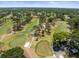 Beautiful aerial view of lush golf course, mature trees, and condo buildings, perfect for avid golfers at 2700 Nebraska Ave # 3-201, Palm Harbor, FL 34684