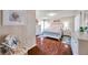 Bright bedroom with hardwood floors, featuring neutral colors, ceiling fan, and access to attached bathroom at 2700 Nebraska Ave # 3-201, Palm Harbor, FL 34684